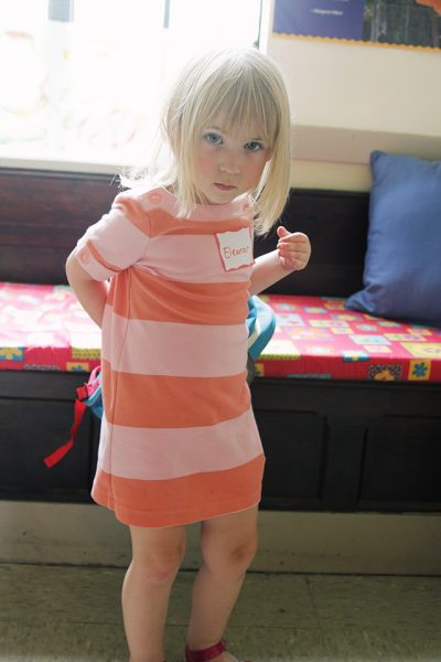 Eleanor Putting on Her Backpack