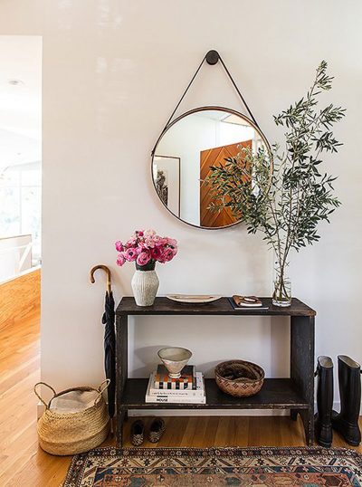 Leather Strap Mirror Above an Antique Table