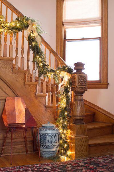 Christmas Garland on Victorian Wooden Staircase, Modern Copper Blu Dot Real Good Chair, Blue and White Pagoda Red Ginger Jar | Making it Lovely