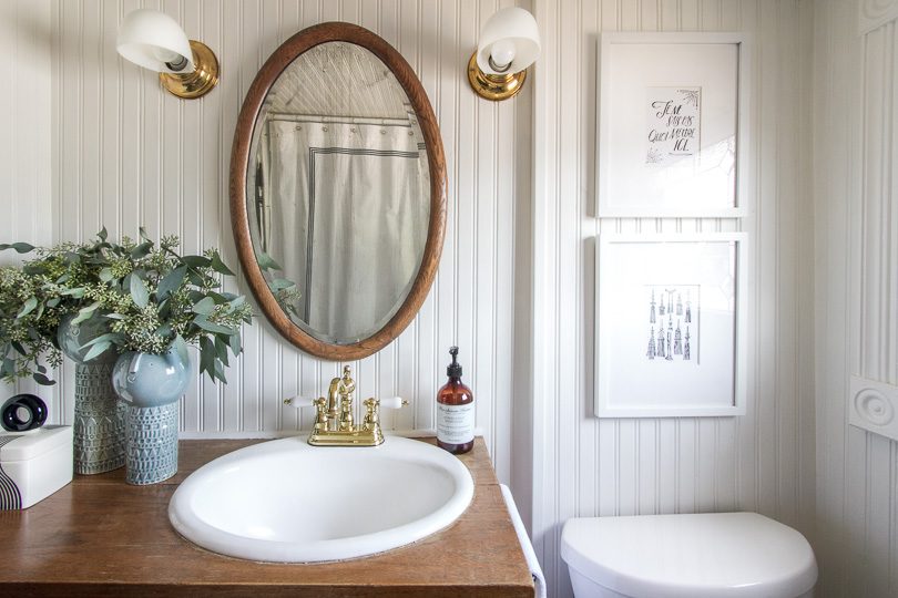 Bathroom with Antique Oval Mirror, Dresser Turned Sink | Making it Lovely