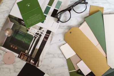 green, pale pink, and ochre yellow paint swatches