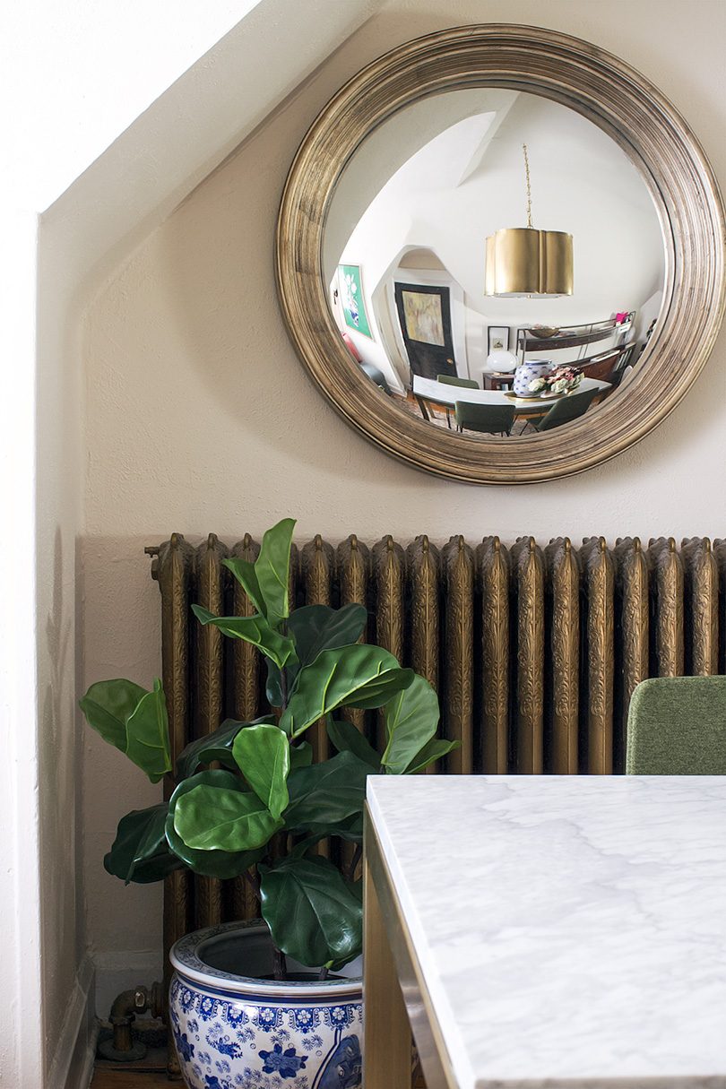 Fiddle Leaf Fig in Blue and White Planter, Brass Cast Iron Radiator, Convex Mirror