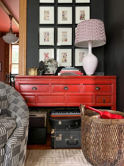 Musical Instruments Stored Beneath a Red Console Table