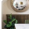 Fiddle Leaf Fig in Blue and White Planter, Brass Cast Iron Radiator, Convex Mirror