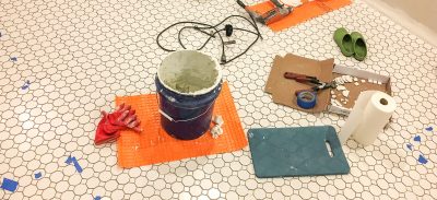 Octagon and Dot Tile Being Installed in a Basement Laundry Room