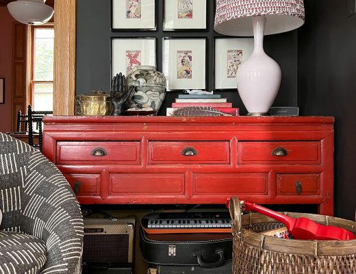 Musical Instruments Stored Beneath a Red Console Table